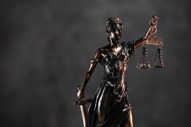 a-bronze-statue-of-lady-justice-holding-scales-and-a-sword-symbolizing-fairness-and-law